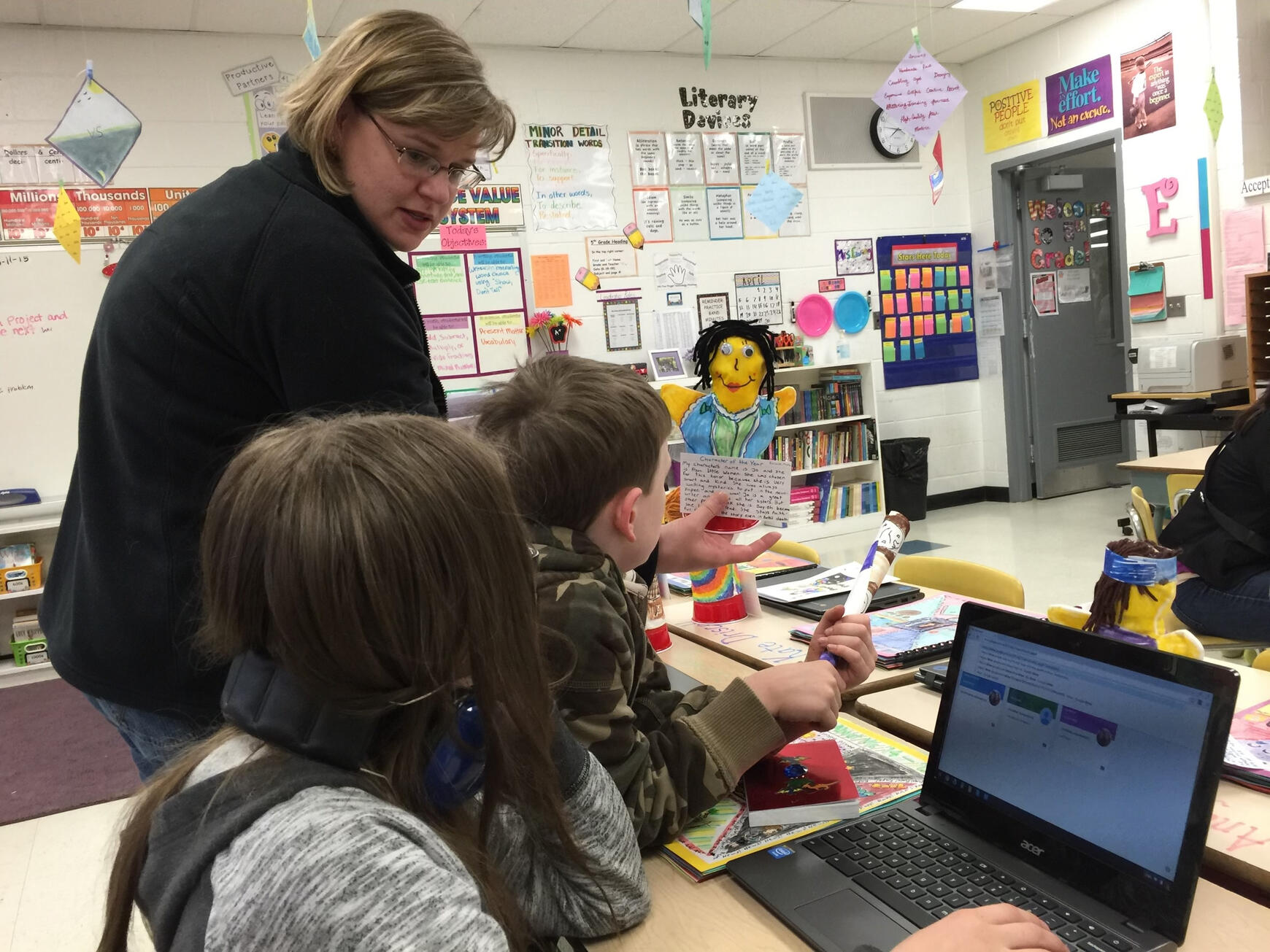 Jennifer teaching a young boy and girl in her classroom